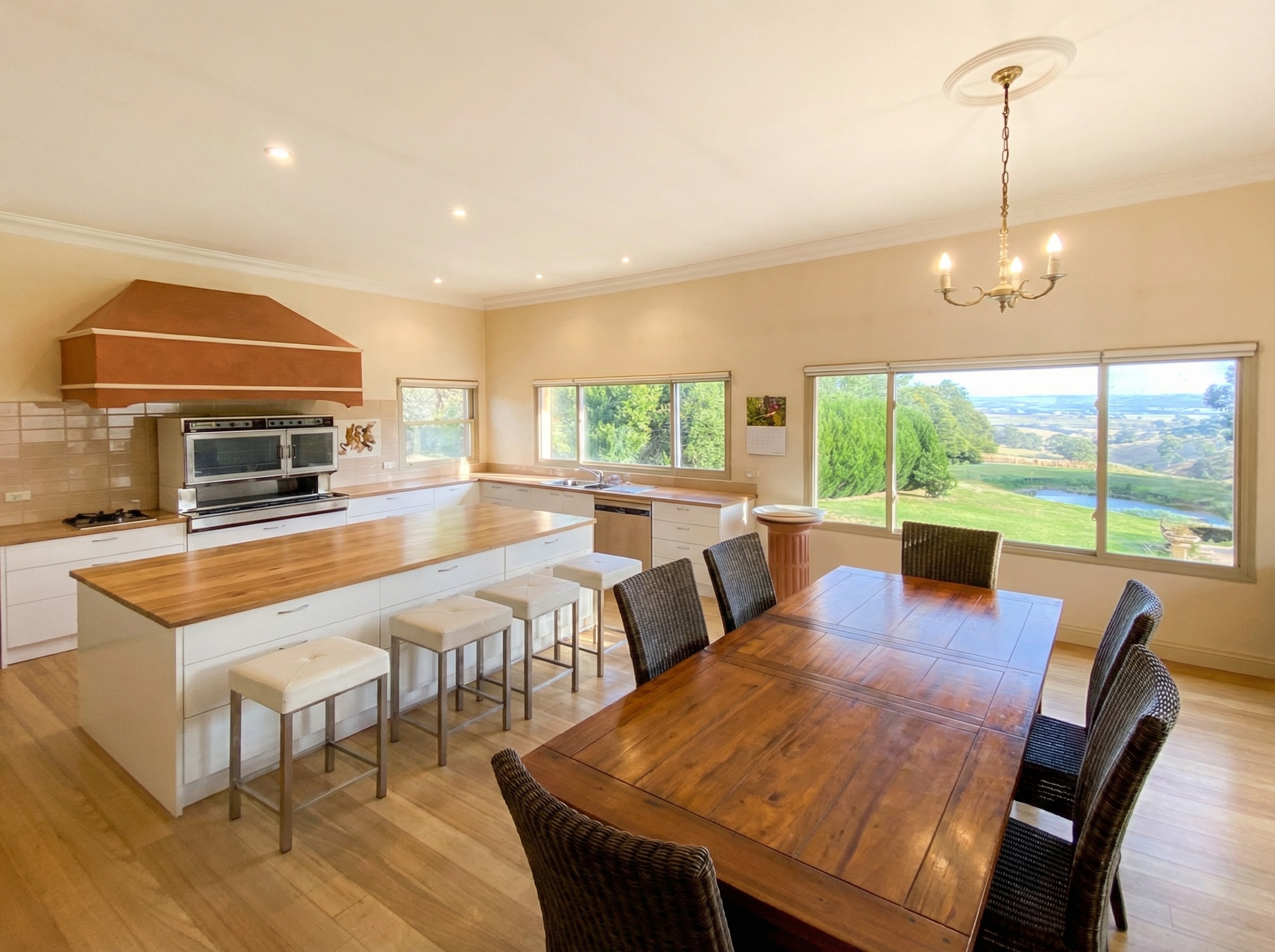 Renovated country kitchen with terracotta rangehood and valley views